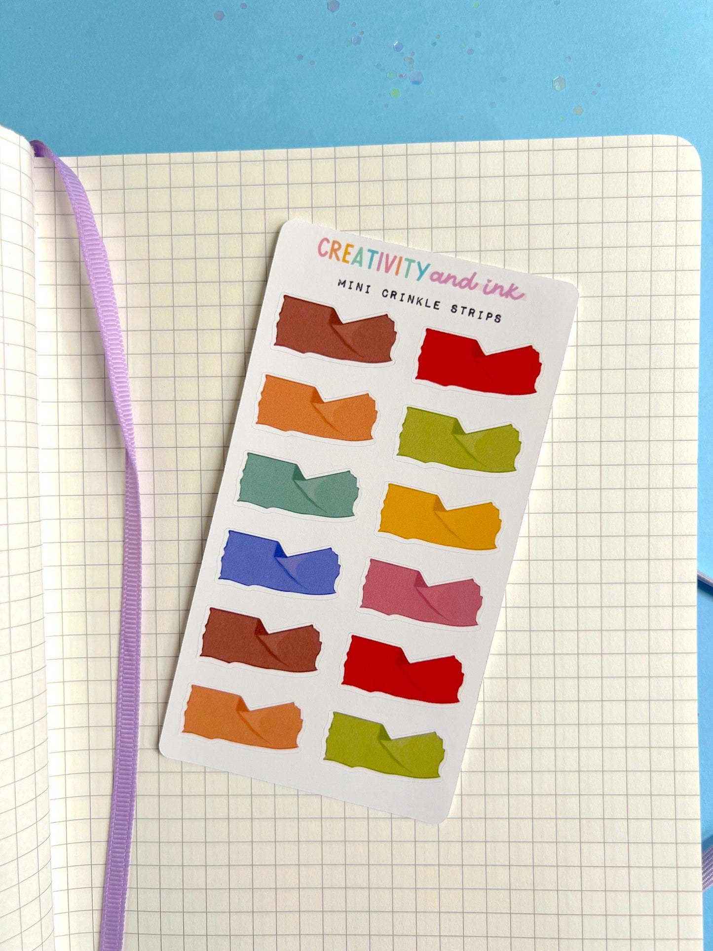 mini life like crinkled paper as a sticker sheet with a notebook background