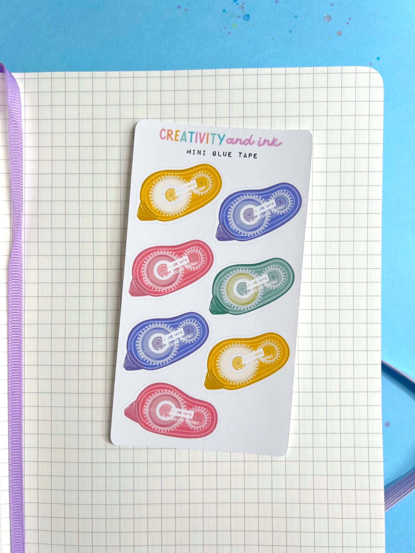mini glue tape runners as a sticker sheet on a notebook background