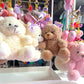 Plush toys and keychains on a display stand with a blurred background