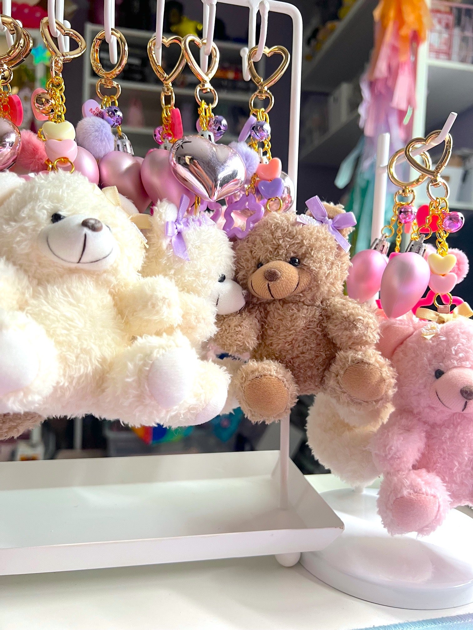 Plush toys and keychains on a display stand with a blurred background