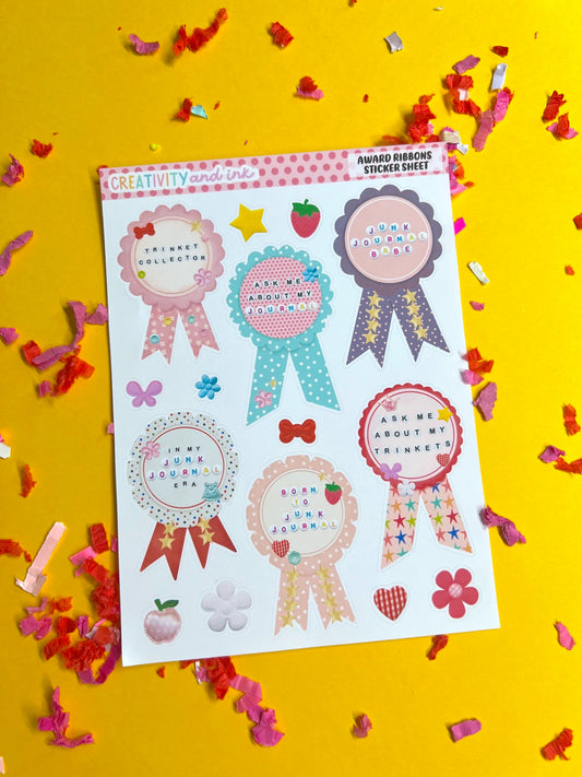 Sheet of decorative stickers with ribbons and text on a yellow background with confetti.