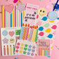 Collection of birthday-themed stationery items on a pink background