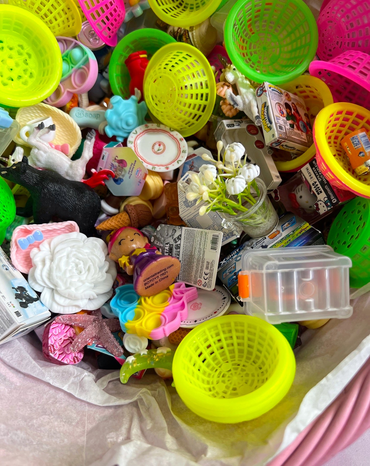 Assorted colorful plastic toys and items on a surface
