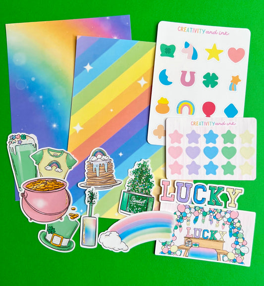 Colorful sticker sheets with rainbow designs and various shapes on a green background