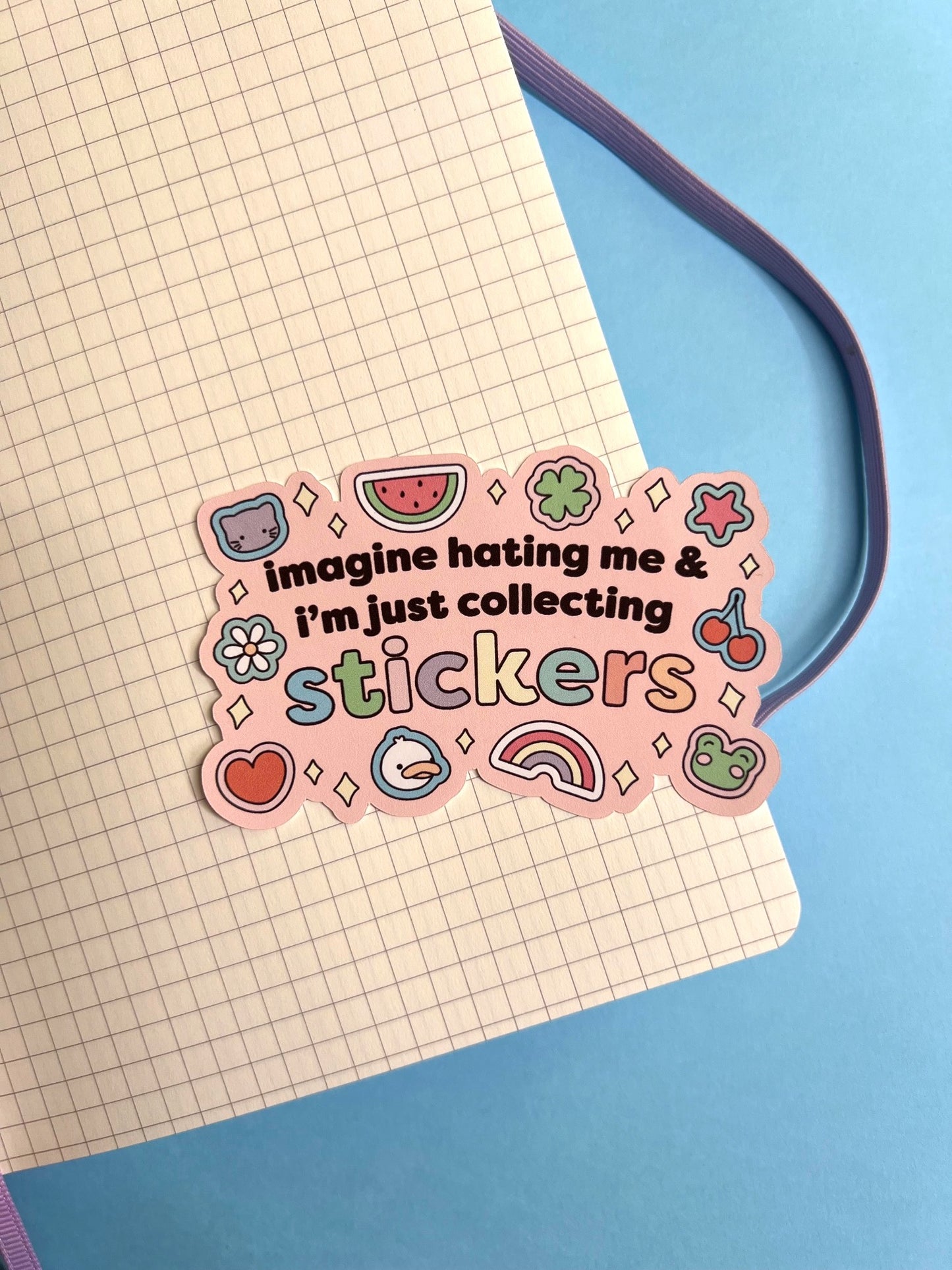 Pink sticker with text and graphics on a notebook