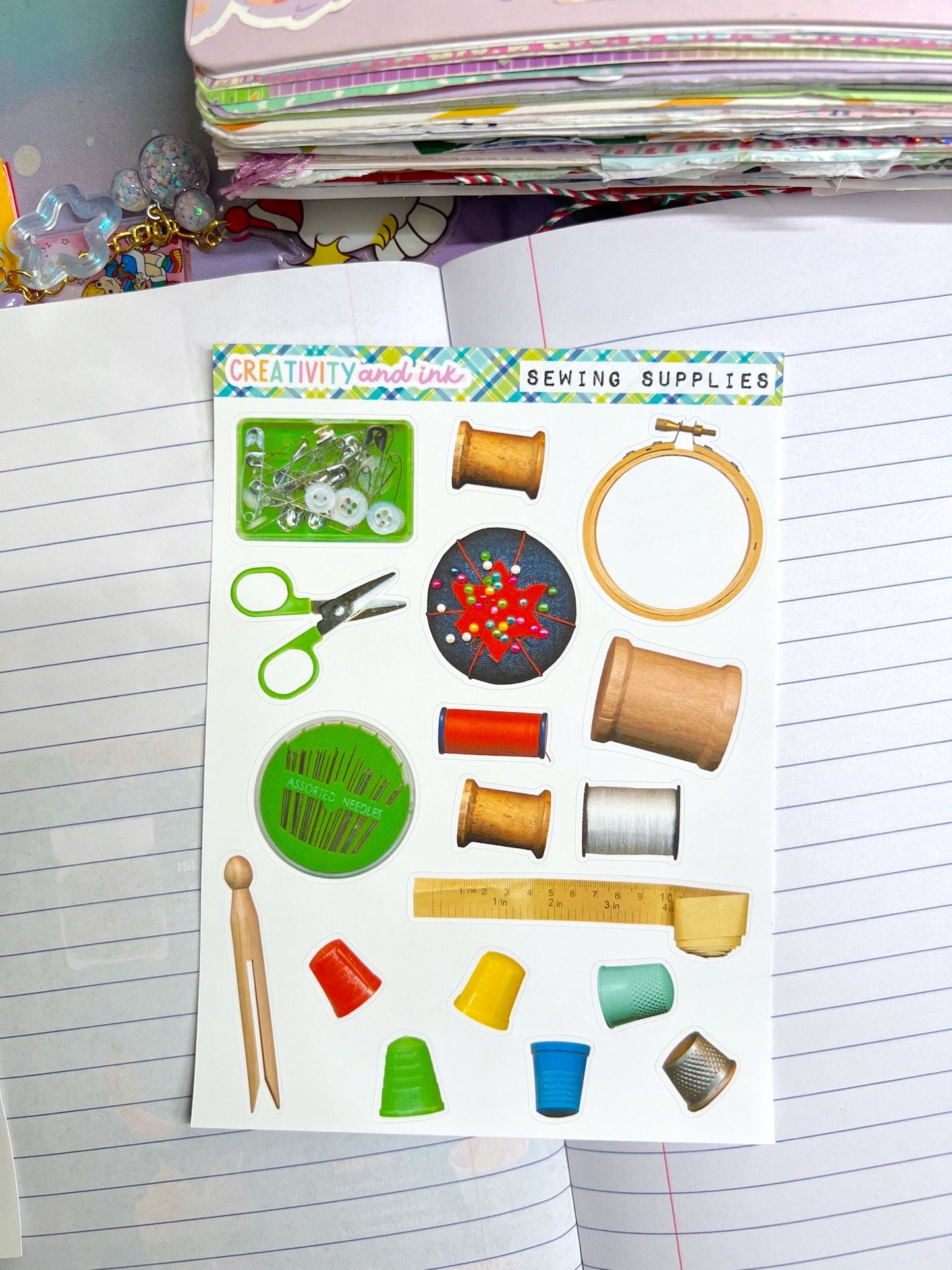Sticker sheet with sewing supplies on a notebook page