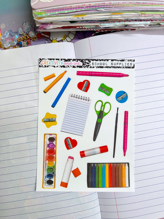Sheet of school supplies stickers on a notebook page with stationery items.