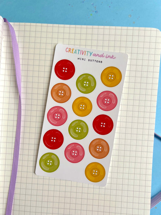 Sheet of colorful button stickers on a grid surface