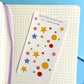 Sheet of colorful star and circle stickers on a notebook 