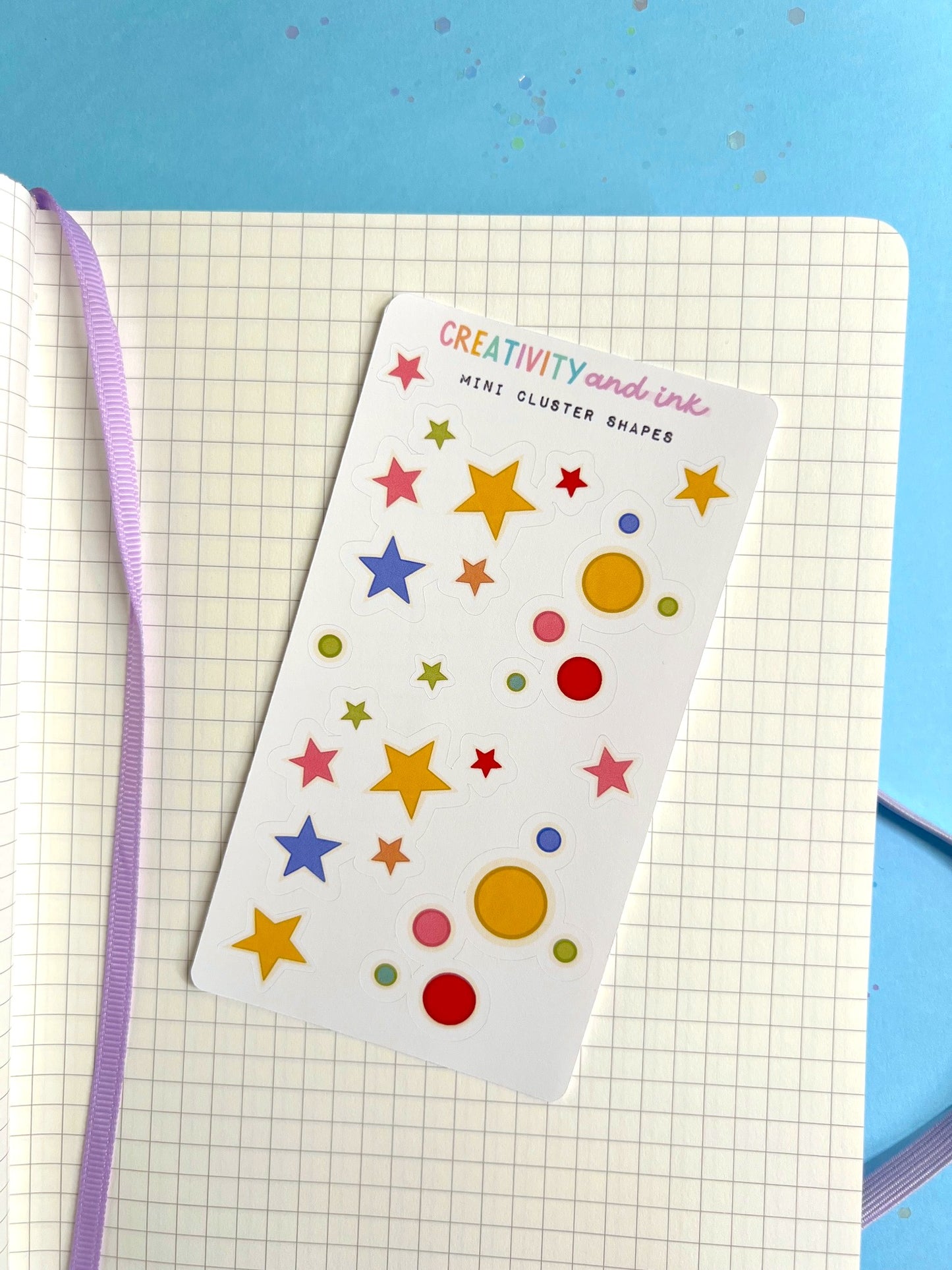 Sheet of colorful star and circle stickers on a notebook 