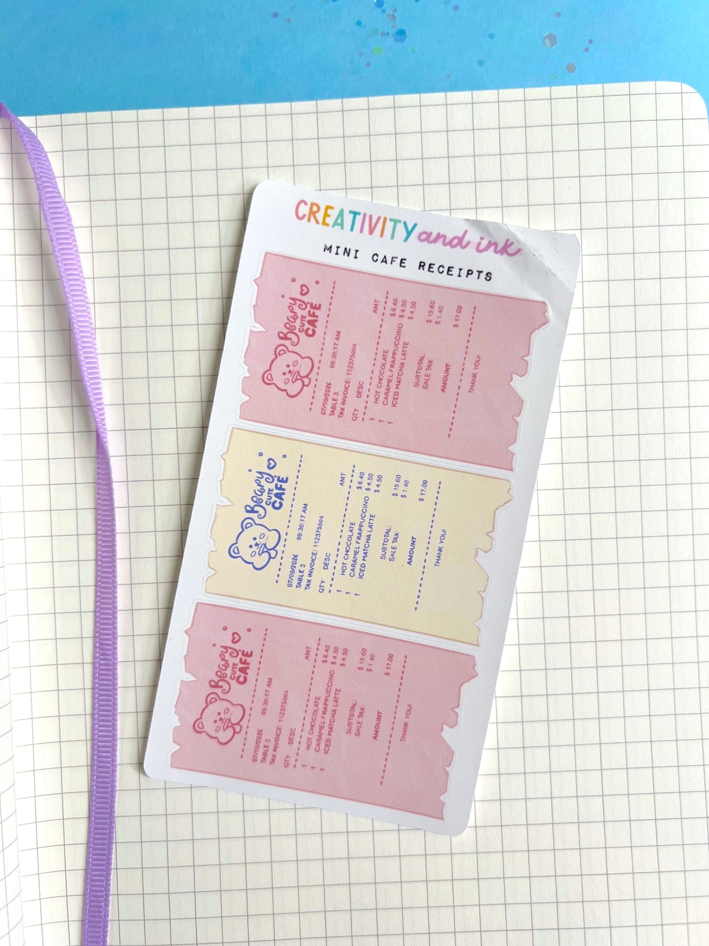 Sheet of mini cafe receipts on a grid notebook with a blue background