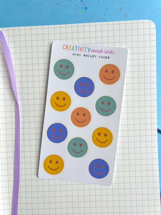 mini smiley faces as a sticker sheet on a notebook background 