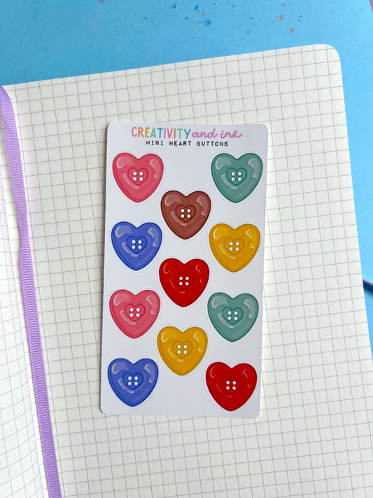 Pack of colorful heart-shaped buttons on a grid notebook page 